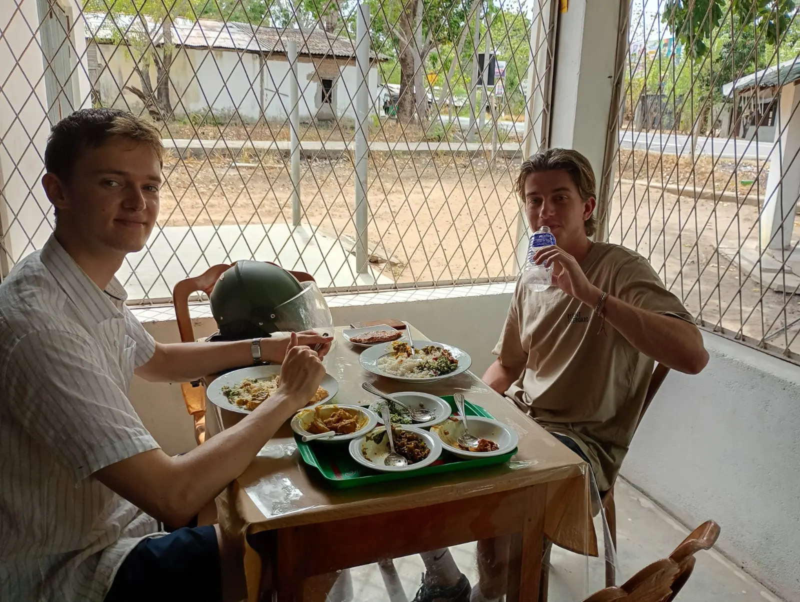Happy guests enjoying a plate of rice and curry